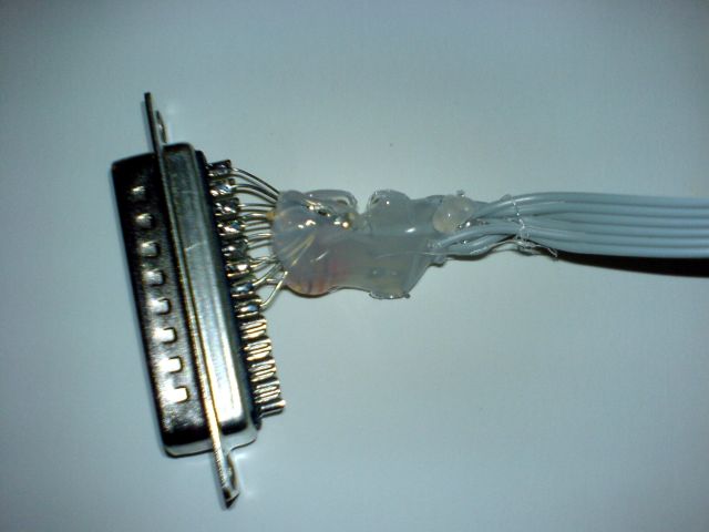 The inside of my parallel port programmer, showing a bulk of hot glue next to the DB-25 connector.