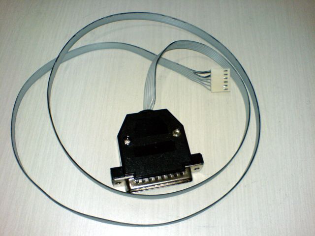 A picture of my finished parallel port programmer, with a black case around the DB-25 connector, hiding the the resistors and the hot glue blob. The flat cable has a black mark over the wire 1.